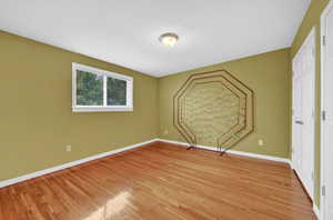 Unfurnished bedroom featuring light hardwood flooring