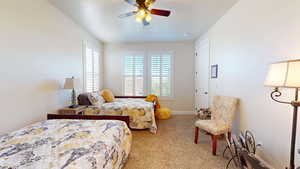 Carpeted bedroom featuring ceiling fan