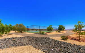 View of jungle gym with tennis court