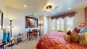 Carpeted bedroom with ceiling fan