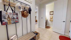 Mudroom with light tile patterned floors