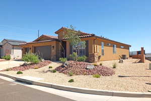 View of front of house featuring central air condition unit and a garage