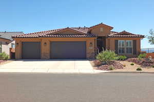 Mediterranean / spanish-style house with a garage