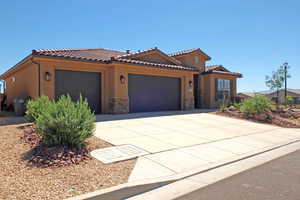 Mediterranean / spanish-style home with a garage