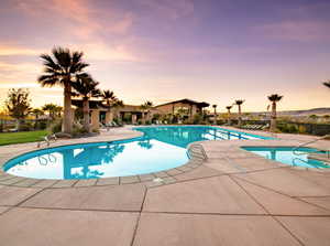 Pool at dusk with a patio area