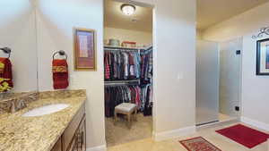 Bathroom featuring vanity, tile patterned floors, and an enclosed shower