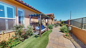 View of yard with a pergola and a patio area