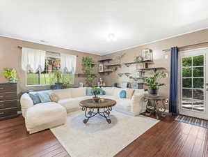 Living room featuring dark wood-style flooring and french doors