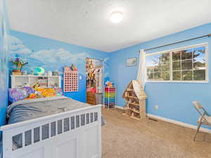 Bedroom #4 with light carpet flooring