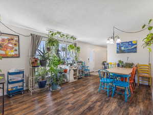 Dining room with dark wood-style flooring