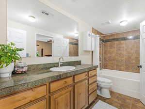 Full bathroom featuring vanity, ceiling fan, tiled shower & large soaking tub