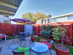 View of patio / terrace featuring a storage unit