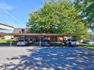 View of car parking featuring a carport