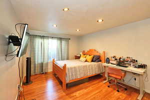 Bedroom with light hardwood / wood-style floors