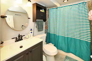 Bathroom with vanity, tile patterned flooring, and toilet