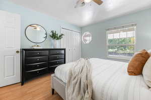 Bedroom featuring a closet, light hardwood / wood-style floors, and ceiling fan