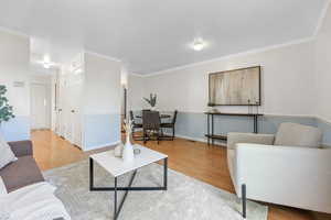 Living room featuring crown molding and wood-type flooring