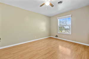 Empty room featuring light hardwood / wood-style floors and ceiling fan