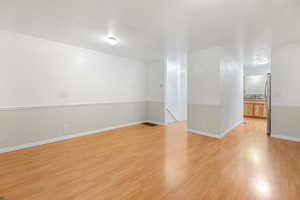 Unfurnished room featuring ornamental molding and light hardwood / wood-style floors