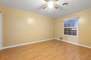 Unfurnished room featuring light wood-type flooring and ceiling fan