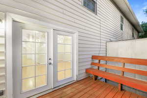 Exterior space with hardwood / wood-style flooring and wooden walls