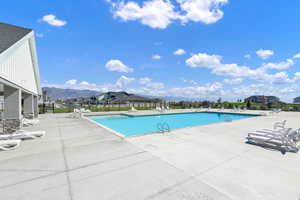 View of pool with a patio and a mountain view