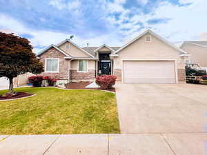 View of front facade with a front lawn and a garage