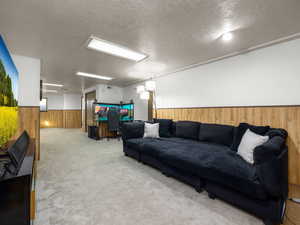 Living room featuring a textured ceiling and carpet