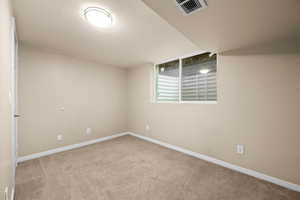 Spare room featuring light colored carpet