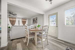 Dining room featuring ceiling fan and wood-type flooring