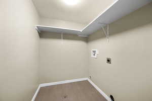 Laundry area with hookup for an electric dryer, hookup for a washing machine, and hardwood / wood-style floors