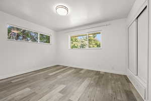 Unfurnished bedroom with a closet and light hardwood / wood-style floors