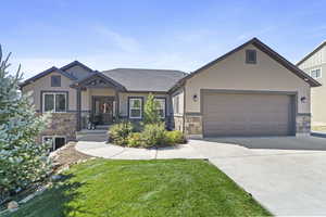 Craftsman-style home with a garage and a front yard