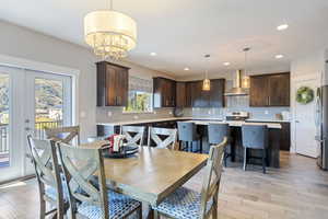 Dining space featuring a notable chandelier and light hardwood / wood-style floors