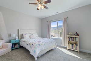 Bedroom featuring ceiling fan and carpet flooring