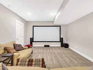 Home theater featuring light carpet