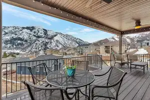 Snow covered deck featuring a mountain view