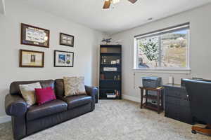 Living room featuring light carpet and ceiling fan