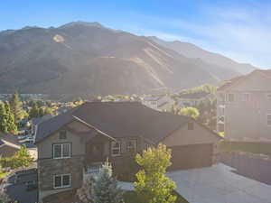 View of front of home featuring a mountain view and a garage