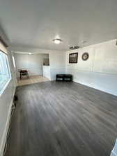 Unfurnished living room with wood-type flooring and a textured ceiling