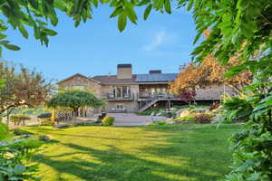 Rear view of property featuring a lawn