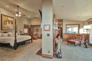 Bedroom with ceiling fan, carpet flooring, a textured ceiling, and vaulted ceiling