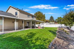 Back of house featuring a patio and a yard