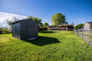 View of yard featuring a storage unit