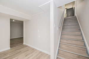 Staircase with hardwood / wood-style floors