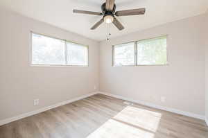 Spare room featuring ceiling fan and light hardwood / wood-style flooring