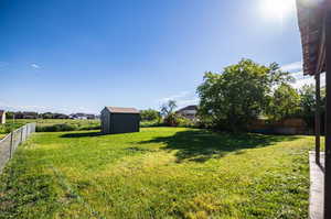 View of yard featuring a storage shed