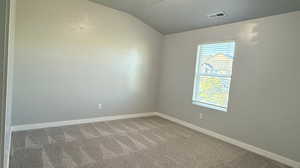 Bedroom 1 with carpet floors and lofted ceiling