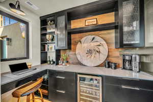 Bar with beverage cooler and decorative backsplash