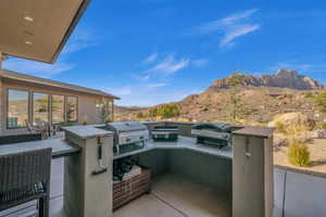 View of patio with a mountain view and area for grilling